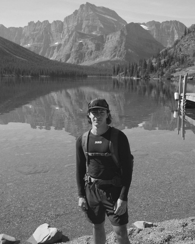 Nicolas Perl standing beside a mountain lake