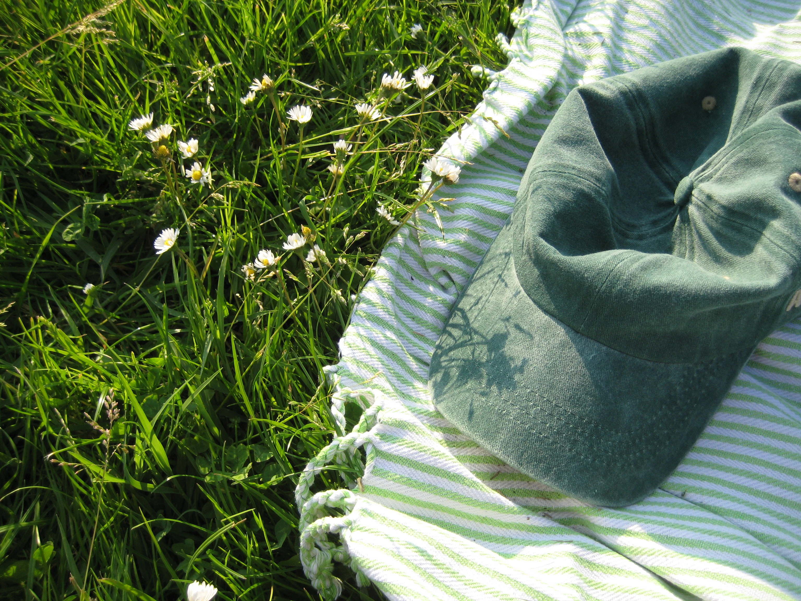 cap and blanket on grass