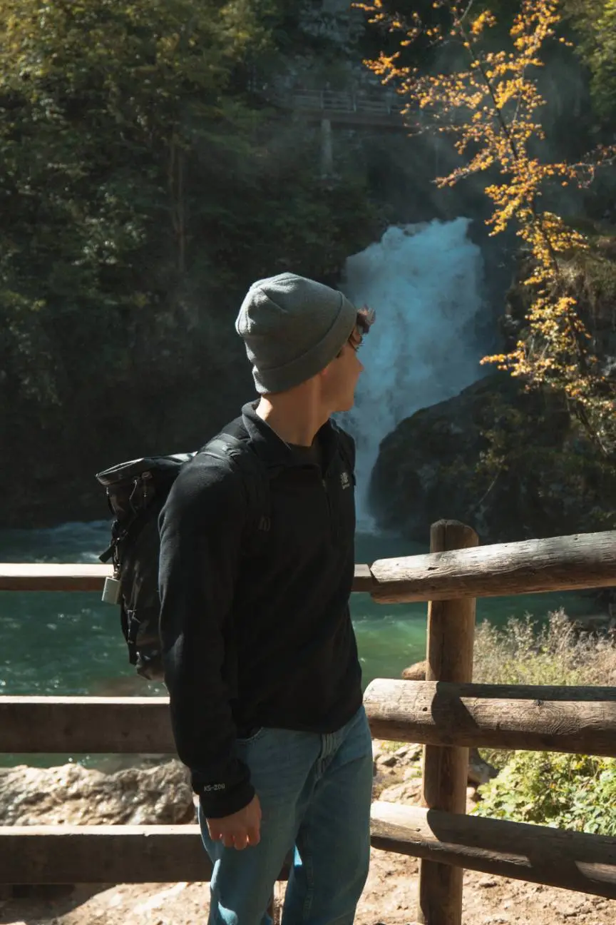 man in front of a waterfall